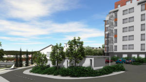 Vy från Kilavägen. En vy över ett planerat flervåningshus med parkeringsområde.