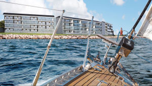 Den här fasaden är miljönämnden inte nöjd med. En skiss över en bostadsbyggnad med flera våningar vid havet. Det ser ut som om bilden är tagen på en segelbåt.