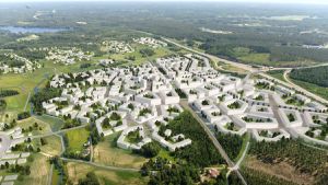 En av de två idéplanerna som har gjorts upp för stationsområdet i Lempola i Lojo. En plankarta från luften över hus ritade längs en järnvägen. Bilden är tecknad.