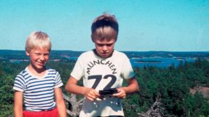 Kaj Arnö i t-skjorta med texten München 1972, på berget Smörasken på Högsar i Nagu där hans farföräldrar är uppvuxna. Kajs äventyrslystnad föddes i barndomen, under grötresorna han gjorde med sin mamma. För varje sked gröt han åt fick han resa en bit i Det Bästas Stora Världsatlas. Kaj Arnö som barn.