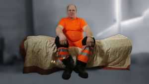 Ari istuu sängyllä.