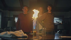 Är du där? undrar Steve, Annie och Peter. Steve, Annie och Peter står vid ett bord och ser förskräckta ut då ett ljus på bordet flammar upp med en enorm låga.