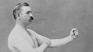 Mustaschmodellen "handlebar" är ett klassiskt fashion statement, bland annat hos boxare i början av 1900-talet. Svartvit på en gammaldags boxare.