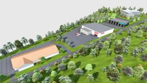 Så här har planerna för hela området sett ut. Den nyöppnade affären syns i mitten. Ett bildmontage som visar hur fyra stora låga affärs- och andra hus placeras på ett område. Husen omges av parkeringsområden och parkaktig skog. Bilden har fågelperspektiv.