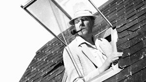 Riemuloma Rivieralla. Monsieur Hulot (Jacques Tati) kurkistaa kattoikkunasta elokuvassa Riemuloma Rivieralla