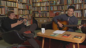 Mathias Rosenlund tilbringar ofta eftermiddagarna i Arcadia Bookshop i Helsingfors. Här tillsammans med vännen Kei Saito. Mathias Rosenlund lyssnar på Kei Saito som spelar gitarr