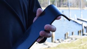 Plasten är formbar vilket enligt Flinkman inte utnyttjats i formgivningen av arbetsbåtarna. En hand som håller i en svart bit HDPE-plast.