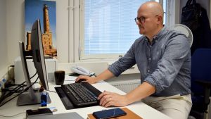 Enligt Sami Salminen visar coronastatistiken att Finlands strategi varit bra. Sami Salminen framför datorn.
