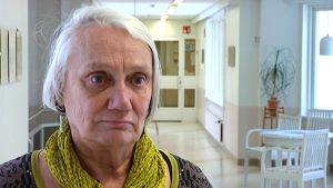 Runa Nyholm jobbade som överläkare på Ekåsens sjukhus från 1983 till 2000. Psykiater Runa Nyholm står i en sjukhuskorridor. Det är Ekåsens sjukhsu i Ekenäs.