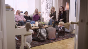 Familjerna Grüssner och Lindberg runt soffbordet. Familjen Grüssner medverkar i Cirkus Familj.