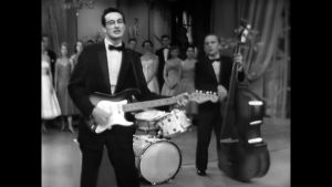 Buddy Hollyn ura loppui lyhyeen traagisen lento-onnettomuuden takia. Buddy Holly soittamassa kitaraa.