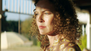 Connie Nielsen som Katrina i Liberty. Karaktären Katrina står på en veranda med solen i ansiktet.