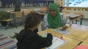 Mammorna lär sig tillsammans med barnen. Här funderar Sadio Abdirahmaan tillsammans med Rosalinda Lion på vänskap. Finska lektion i Rajakylän koulu i Råby i Vanda med invandrarmammor med på lektionen.