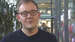 Studiehandledare Tony Valtonen, säger att programmet är en möjlighet att testa på företagsamhet i en trygg miljö. En man i glasögon i en skolkorridor.
