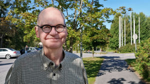 Heikki Kaukoranta säger att medierna kontaktas i sista hand när det gäller smittspårningen. Mansperson står utomhus i sommargrönska.