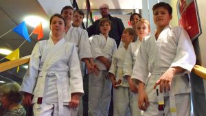 Kimitoöns Aikidojuniorer och Juha Ruusuvuori i bakgrunden. Kimitoöns aikidojuniorer står i en trappa.