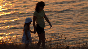 Barnen ser helst sina föräldrar nyktra säger Janne Takala kvinna och liten flicka går på stranden i kvällssolen