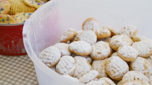 Familjen har bakat kahk, en typ av kex som äts i arabiska länder under id al-fitr. Kahk kex i en vit bunke på en rutig bordsduk.