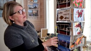 Sommar, sommar, sommar - Maria Pick tror att skärgårdsföretagare inte ser att också vintern har potential som turistsäsong. Maria Pick tittar på en ställning med vykort med somriga skärgårdsmotiv.