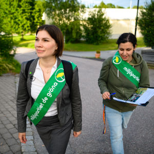 Annika Hirvonen och hennes partikollega Ajda Asgari går på en gata.