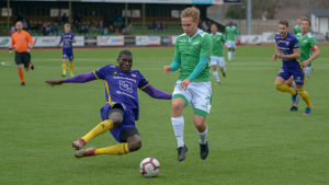 PEPO:s Alieu Ceesay, som tidigare spelat för BK-46 i Karis kämpar om bollen med EIF:s Matias Lahti. PEPO:s Alieu Ceesay och EIF:s Matias Lahti kämpar om bollen.