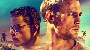 Papillon. Elokuvan graafinen markkinointikuva. Turkoosilla taustalla päänäyttelijöiden Charlie Hunnam ja Rami Malek päät katsovat eri suuntiin.