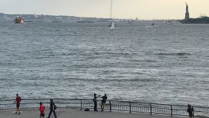 På södra Manhattan är utsikten fin, men översvämningsrisken hög Utsikt över södra Manhattan, joggare på stranden