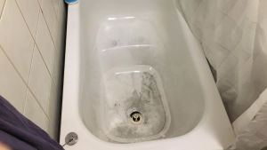 Kranvattnet var fortfarande svart hemma hos Katja Simonen på tisdag kväll, efter spolningsarbetet. Badkar med svart beläggning på bottnen.