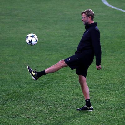 Jürgen Klopp sparkar en boll på Liverpools träning.