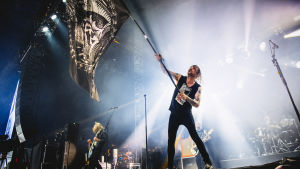 Norska Kvelertak. Norska bandet Kvelertaks sångare Ivar med en stor flagga på scenen på Tuska 2019.