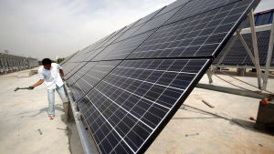 En av de första solpanelsanläggningarna installerades i Qinghaiprovinnsen 2008 En man arbetar med solpaneler i Qinghaiprovinsen i Kina