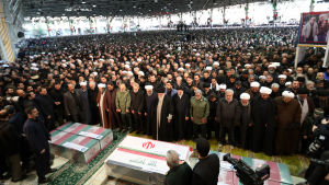 Uppslutningen var stor till begravningsceremonin. Ayatolla Khamenei står längst fram i mitten, framför den mittersta kistan. Människor samlade till en begravning. Kistorna i förgrunden.
