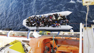 Många flyktingar drunknar på väg över Medelhavet till Europa. on 20 April 2015 shows a boat with refugees next to the cargo ship 'OOC Cougar' in the Mediterranean sea on 05 February 2015. The ships of the German shipping company Opielok Offshore Carriers have rescued more than 1,500 people in the Mediterranean sea s