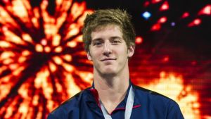 James Feigen festade tillsammans med Lochte. Simmaren James Feigen ler vid prisutdelning OS i Rio 2016