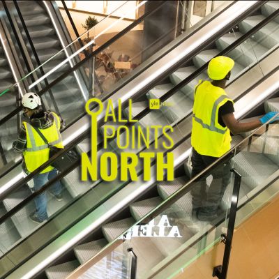 Photo of construction workers on escalators, featuring the All Points North podcast logo.