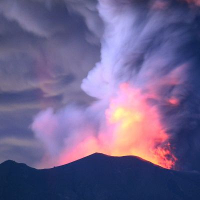 Vulkanen Agungs utbrott fotograferat från Kubu 28.11.2017. Glödande sken och rök stiger från vulkanen mot en mörk natthimmel. 