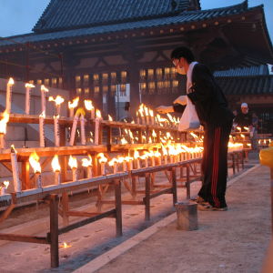 Kuolleiden sielujen muistoksi sytytettyjä kynttilölöitä japanilaistemppelin pihalla.