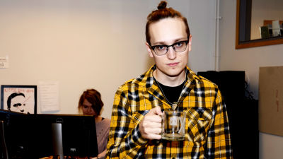 Axel Åhman håller en mugg i handen.