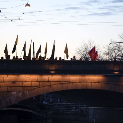 Uusnatsien Kohti vapautta! -marssi ylittämässä Pitkääsiltaa Kaisaniemestä Hakaniemeen natsien hakaristilippujen kanssa Helsingissä itsenäisyyspäivänä 6. joulukuuta 2018