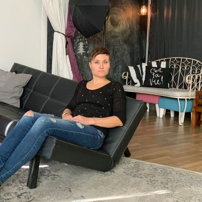 Heidi Noponen istuu risalla sohvalla