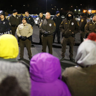Människor i Ferguson väntar på att få höra domen om polisen som skjöt Michael Brown i Ferguson.