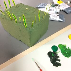 Ta hjälp av lite stickmassa eller lera att sticka bladen i medan de torkar. Målade blad till en svärmorstunga i miniatyr.