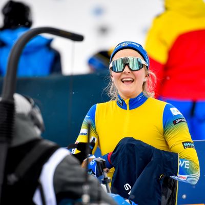 Stina Nilsson hymyilee hiihtolasit silmillään pikakisan maalissa.