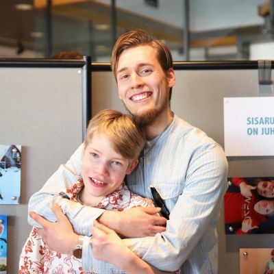 Veljekset halaavat toisiaan ja hymyilevät