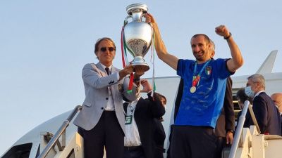Roberto Mancini och Giorgio Chiellini står framför flygplanet med pokalen.