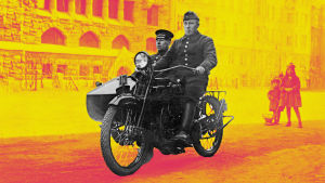 Palomies ja ruiskumestari ajavat Helsingin palolaitoksen sivuvaunullisella Harley-Davidson-moottoripyörän 1920-luvulla. Taustalla alipäällystön lapsia.