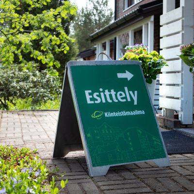 Kiinteistövälittäjän esittelykyltti asunnon edessä.