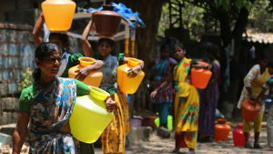 Den akuta vattenbristen gör att människor måste hämta sitt vatten på långt håll. Ev värmebölja har lett till svårigheter i Bangalore, Indien