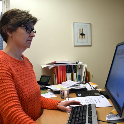 Carola Lindholm vid en dator. 