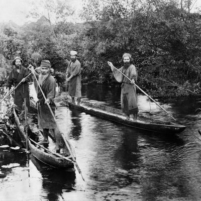 En svartvit bild på allvarliga män i kanoter.